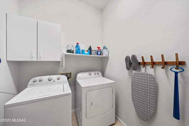 laundry area featuring cabinets and washing machine and dryer