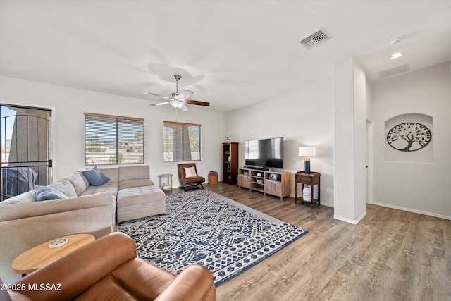 living room with hardwood / wood-style floors and ceiling fan