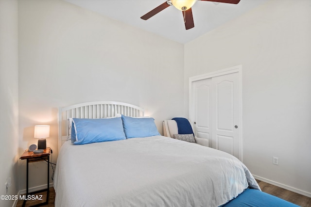 bedroom featuring ceiling fan, dark hardwood / wood-style flooring, and a closet