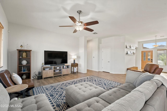 living room with wood-type flooring and ceiling fan