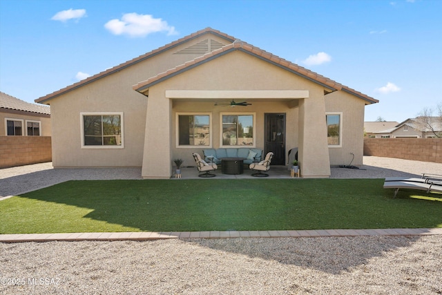 rear view of property with an outdoor hangout area, a lawn, ceiling fan, and a patio area