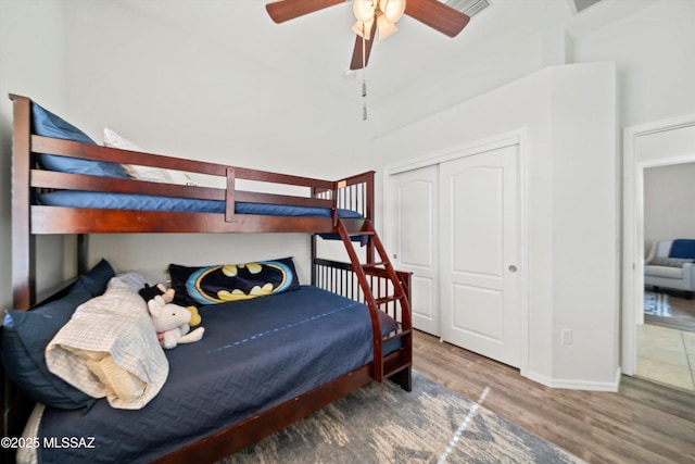 bedroom with ceiling fan, hardwood / wood-style floors, and a closet