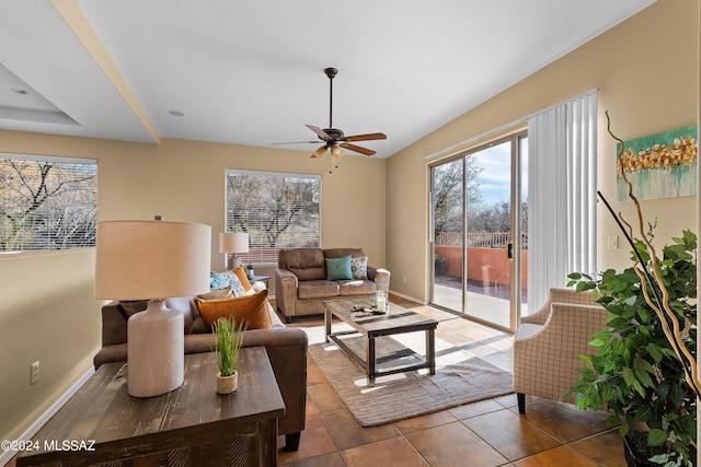 tiled living area with a ceiling fan and baseboards