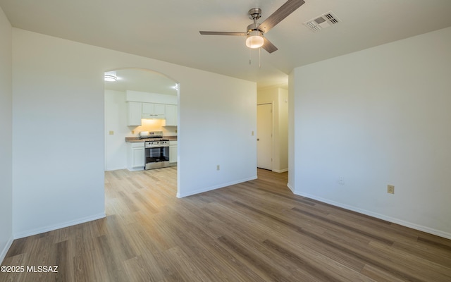 spare room featuring ceiling fan and light hardwood / wood-style flooring