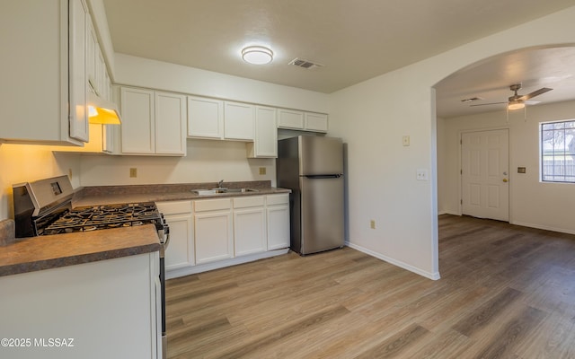 kitchen featuring white cabinetry, stainless steel appliances, sink, and light hardwood / wood-style flooring