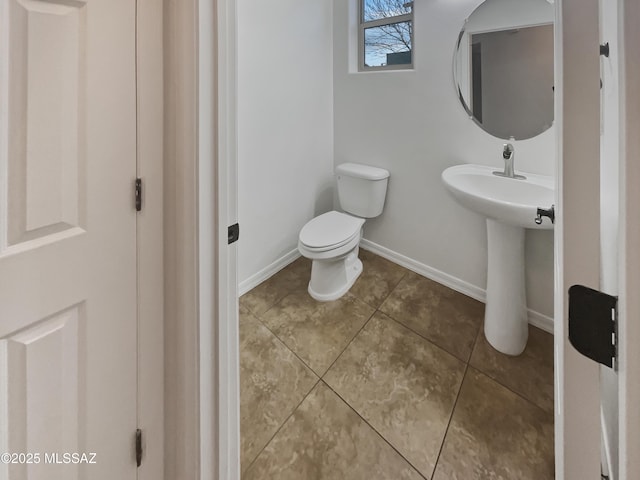 bathroom with tile patterned floors, toilet, and sink