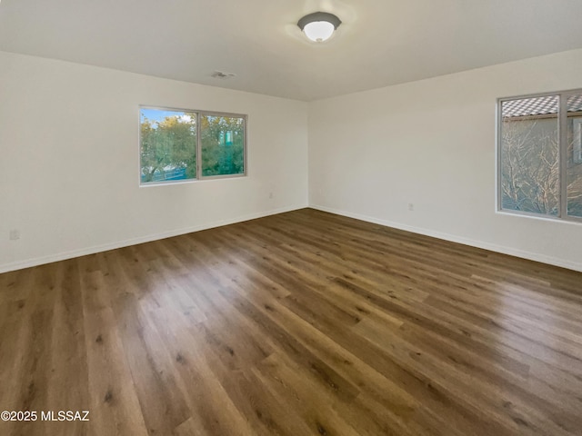 empty room featuring dark wood-type flooring