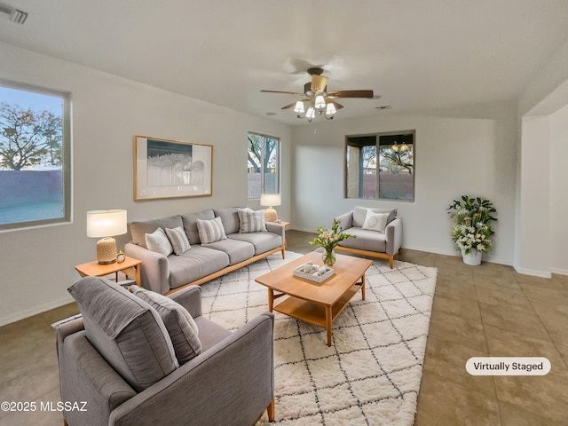 living room featuring light tile patterned floors and ceiling fan