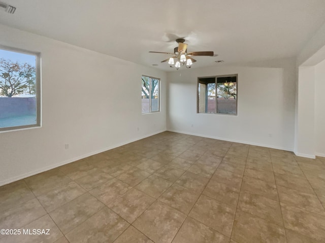 empty room with light tile patterned floors and ceiling fan