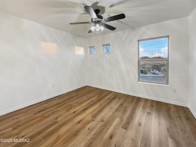 spare room featuring hardwood / wood-style flooring and ceiling fan