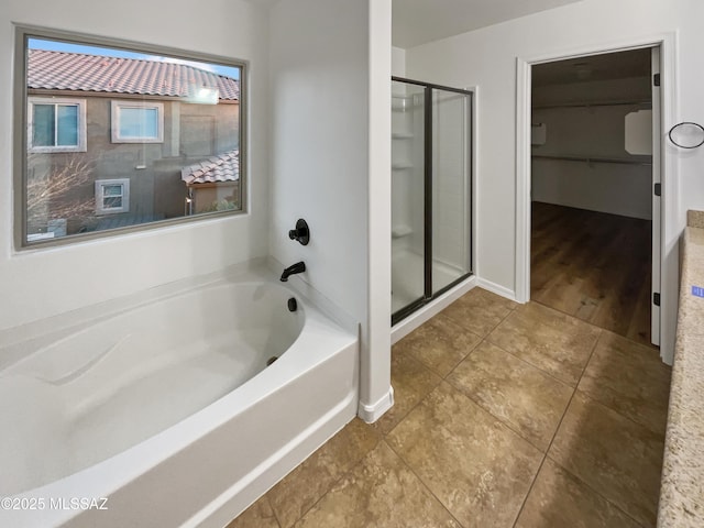 bathroom featuring plus walk in shower and tile patterned flooring