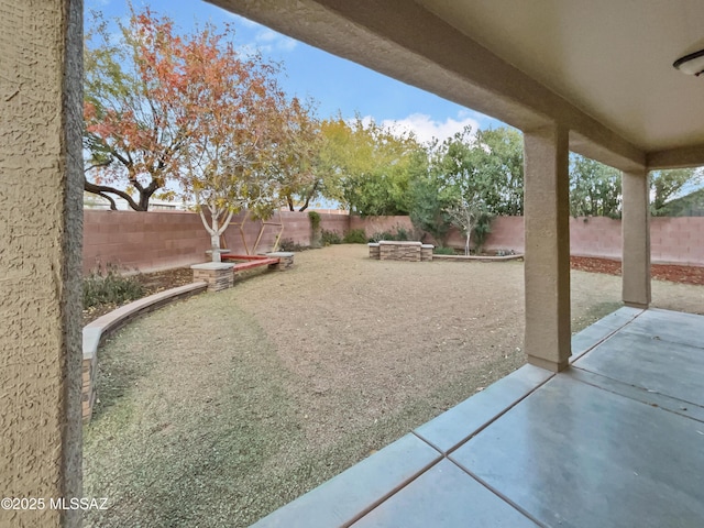 view of yard with an outdoor fire pit and a patio area