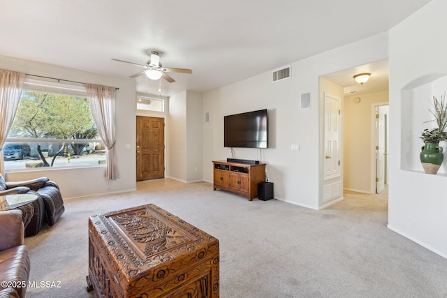 carpeted living room featuring ceiling fan