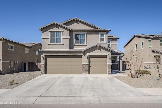 view of front of property with stone siding, concrete driveway, an attached garage, and stucco siding