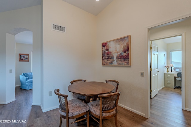 dining space with wood-type flooring