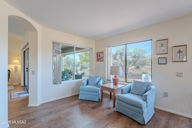 sitting room featuring a textured ceiling and light hardwood / wood-style floors