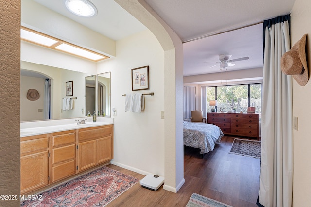 bathroom featuring wood-type flooring, vanity, and ceiling fan