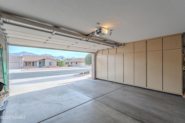 garage featuring a garage door opener and a mountain view