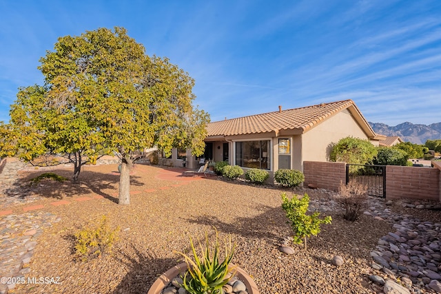 rear view of house featuring a mountain view