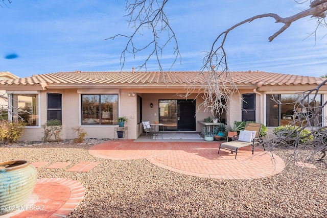 back of property with a patio