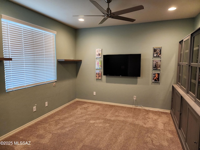 interior space with light colored carpet and ceiling fan