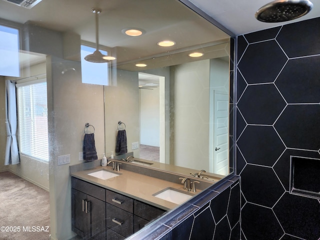 bathroom with walk in shower and vanity