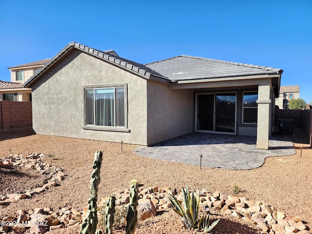 rear view of property featuring central AC and a patio