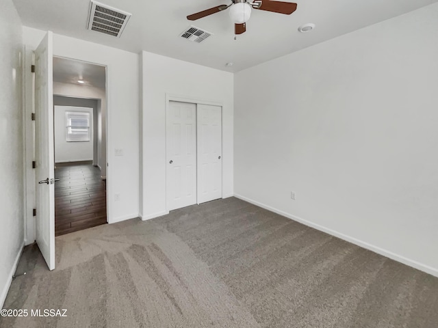 unfurnished bedroom with carpet floors, a closet, and ceiling fan