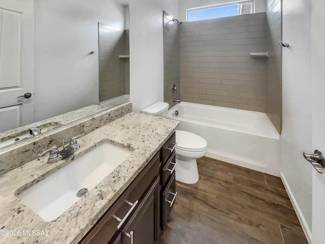 full bathroom with hardwood / wood-style flooring, vanity, tiled shower / bath combo, and toilet