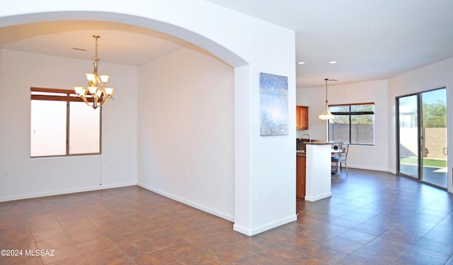 spare room featuring a notable chandelier