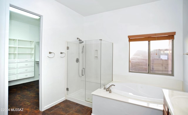 bathroom with vanity and shower with separate bathtub