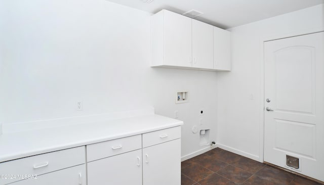 laundry area featuring electric dryer hookup, hookup for a washing machine, and cabinets