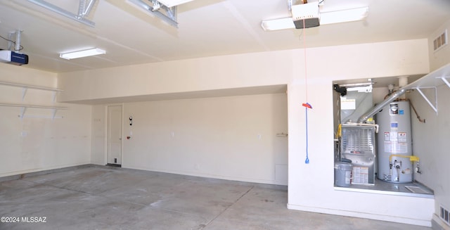 garage featuring water heater and a garage door opener