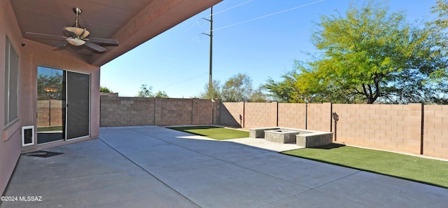 view of patio featuring a fire pit and ceiling fan