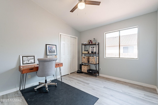 office area with lofted ceiling, ceiling fan, baseboards, and wood finished floors