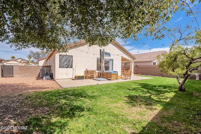 back of house with a fenced backyard, a patio, and stucco siding