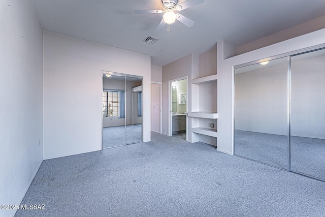 unfurnished bedroom featuring ensuite bathroom, carpet, and ceiling fan