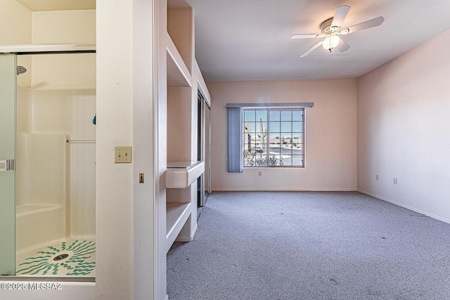 carpeted spare room featuring ceiling fan