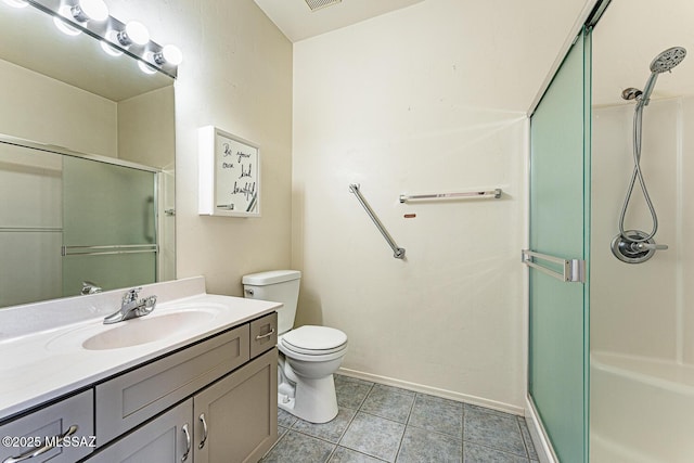 bathroom with an enclosed shower, vanity, tile patterned floors, and toilet