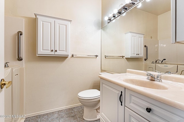 bathroom featuring tile patterned flooring, vanity, and toilet