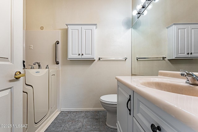 bathroom with vanity, tile patterned floors, and toilet