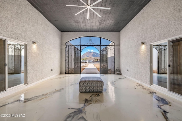 unfurnished room with a towering ceiling, a wealth of natural light, and wooden ceiling