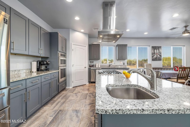 kitchen featuring a large island, sink, island range hood, and appliances with stainless steel finishes