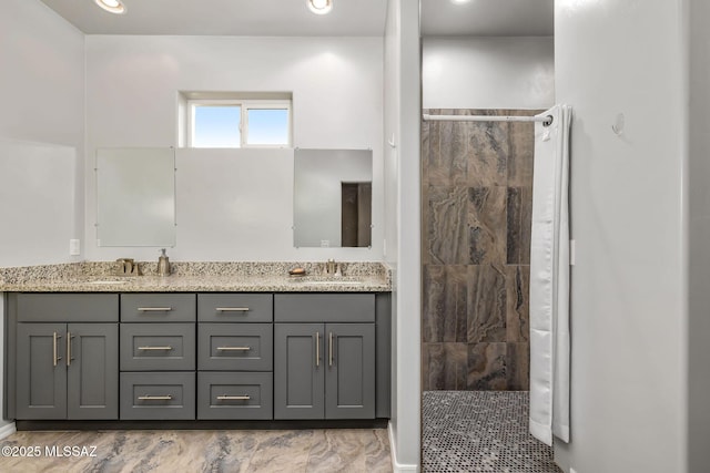 bathroom featuring vanity and tiled shower