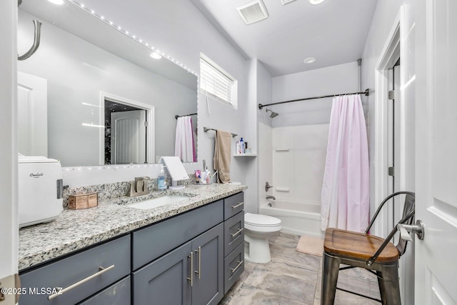 full bathroom with vanity, toilet, and shower / tub combo