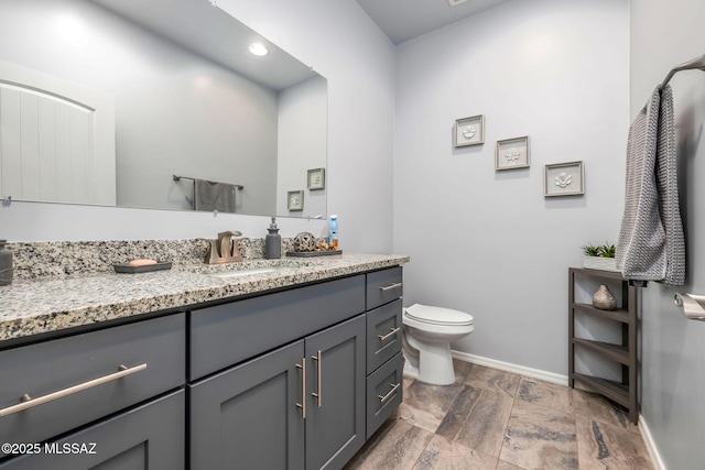 bathroom featuring vanity and toilet