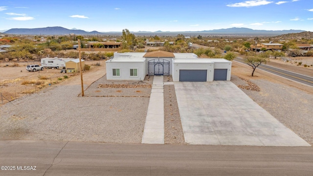 southwest-style home featuring a mountain view and a garage