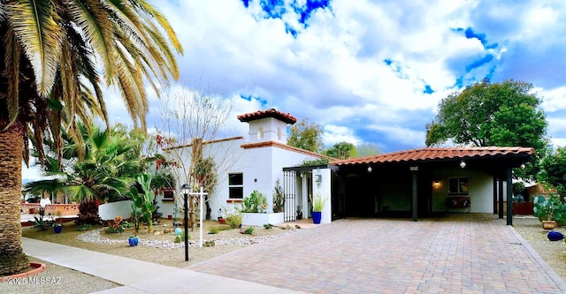 mediterranean / spanish home featuring a carport