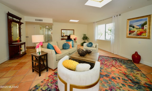 tiled living room with a skylight