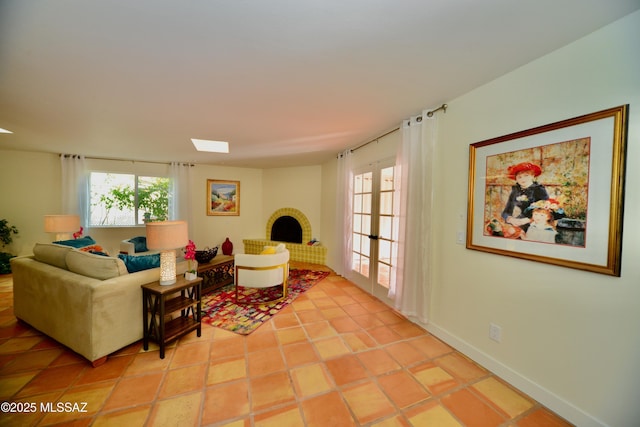 tiled living room featuring french doors and a wealth of natural light